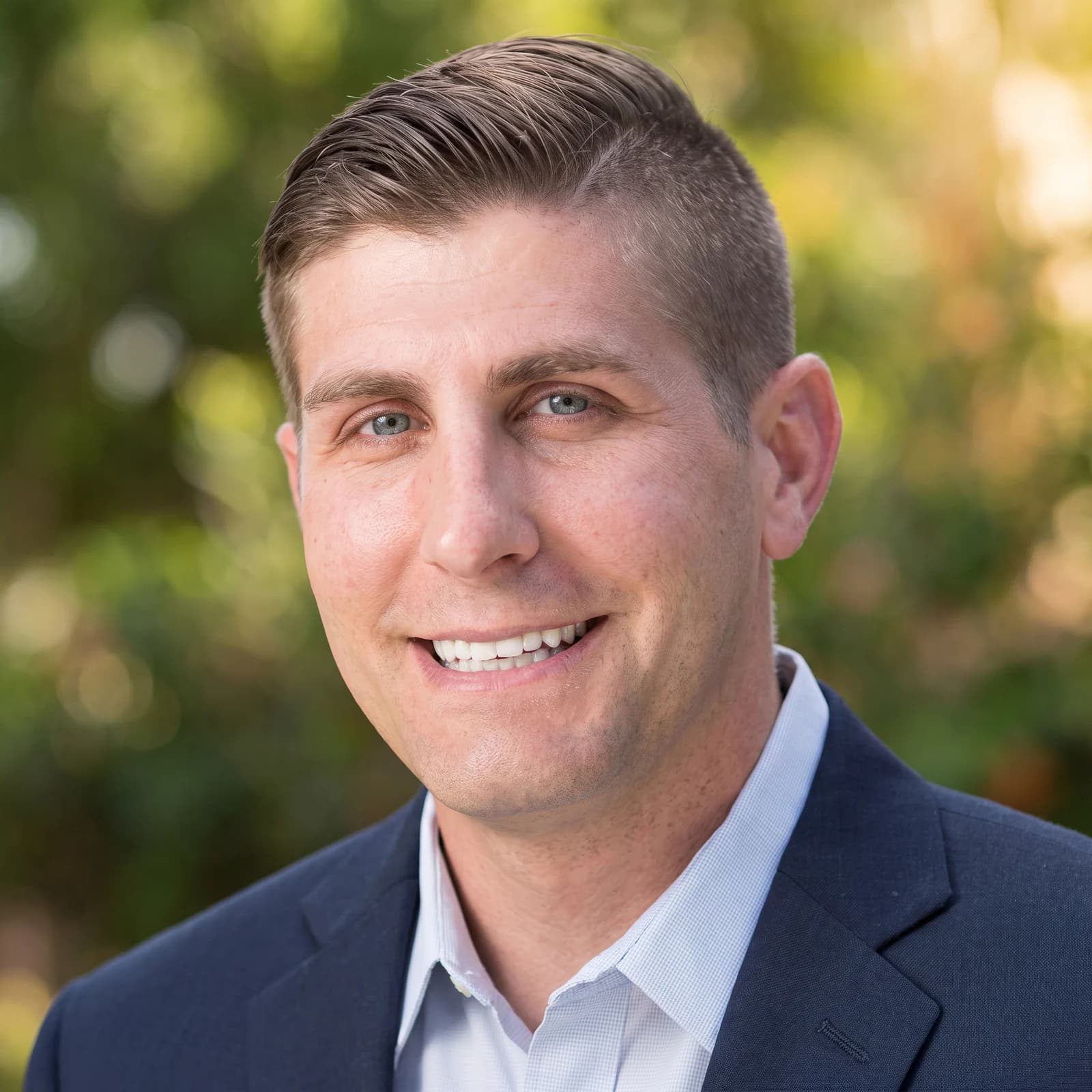 Dr. Brent Woodmansee smiling in a navy suit