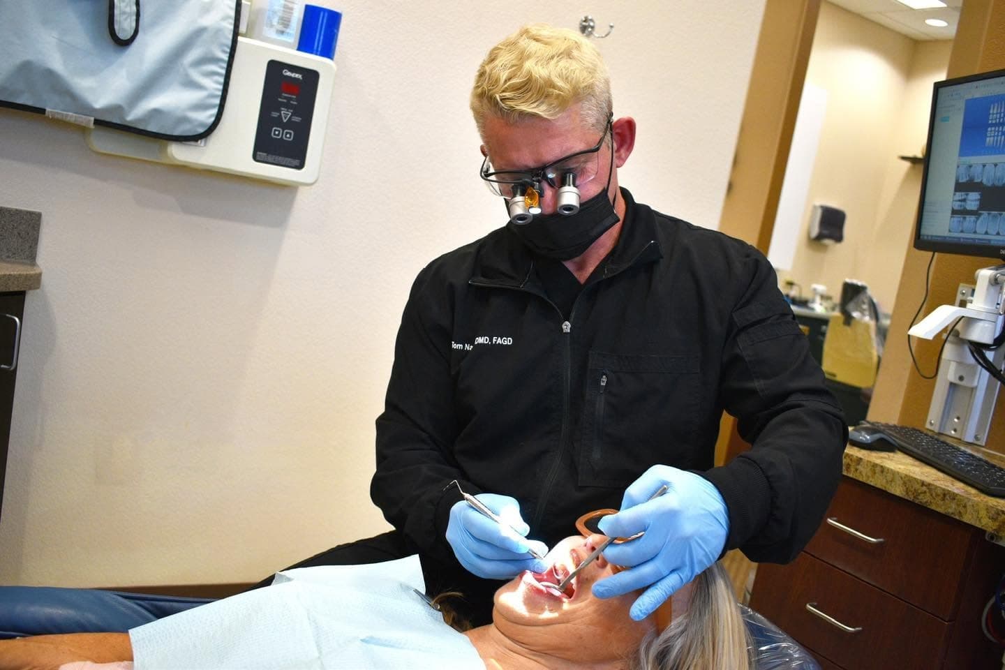A Mountain View Smiles dentist treating a patient with magnification
