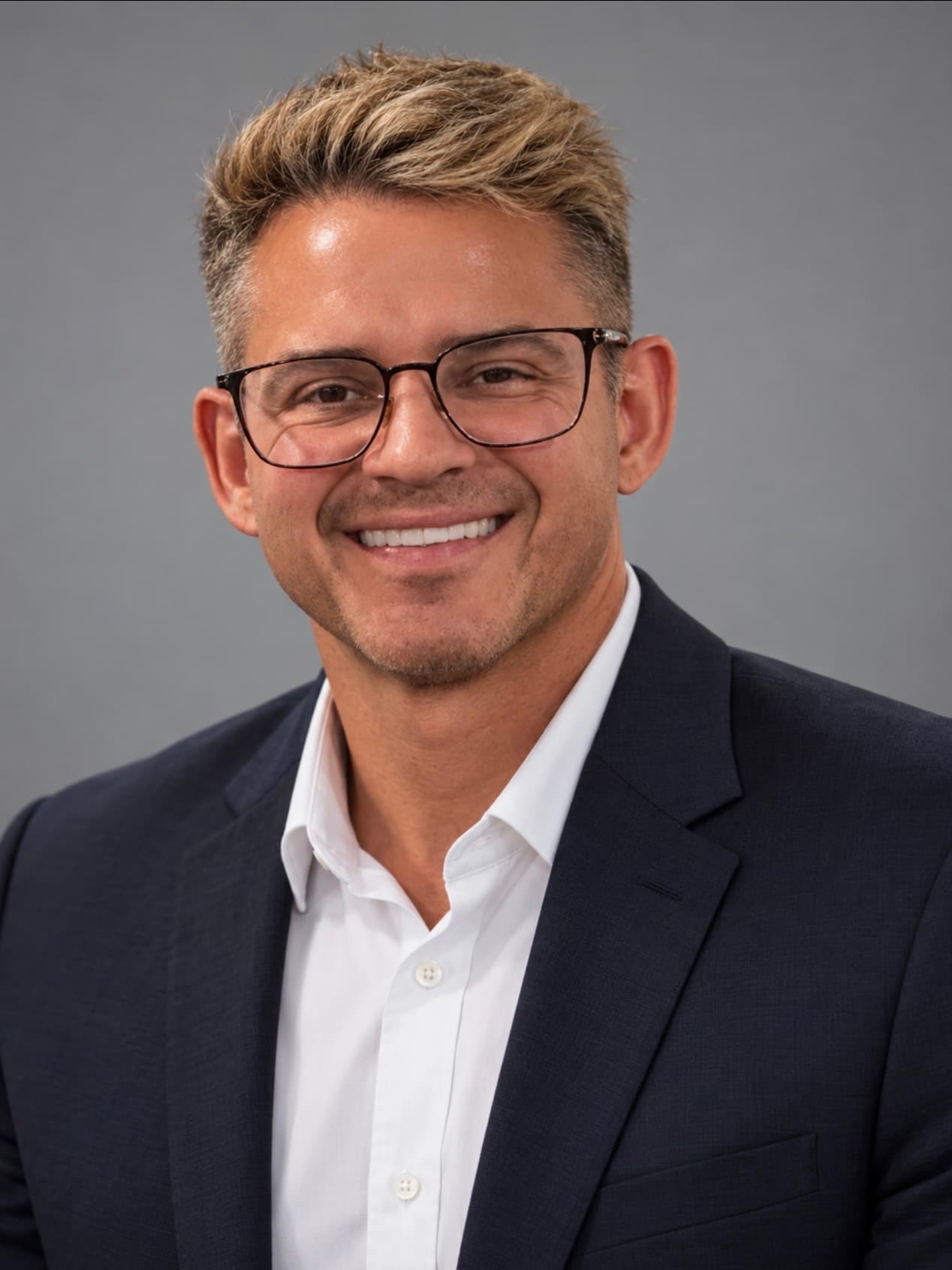 Dr. Tom Nack, a Scottsdale dentist at Mountain View Smiles, smiling in a navy suit