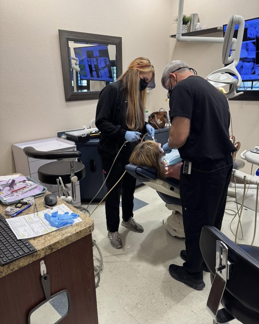 The Mountain View Smiles team caring for a patient in the treatment room